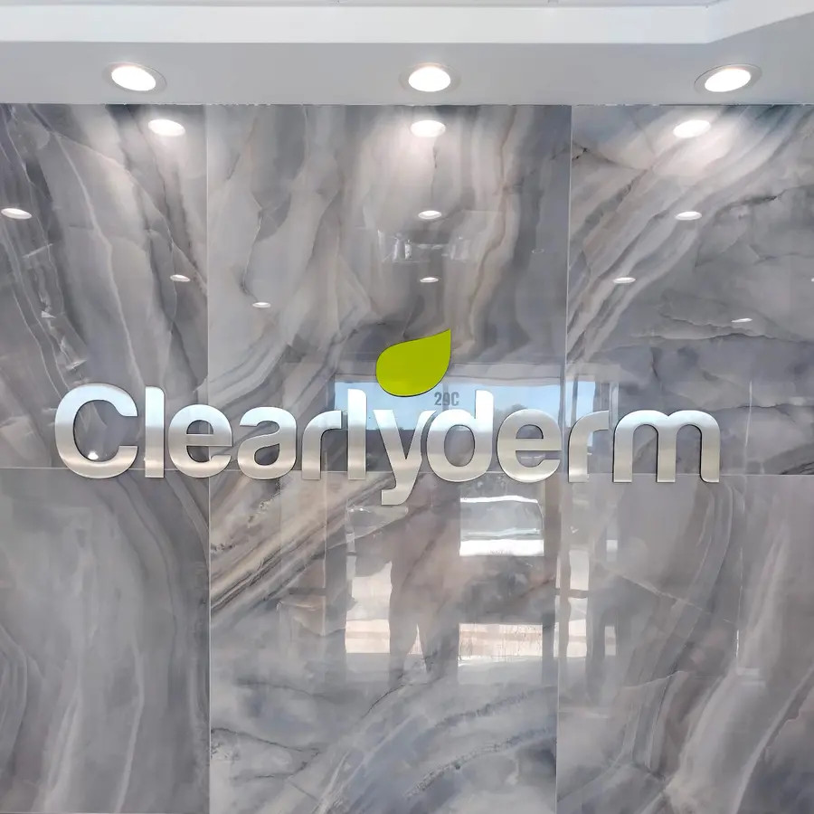 Illuminated letters on a marble lobby wall