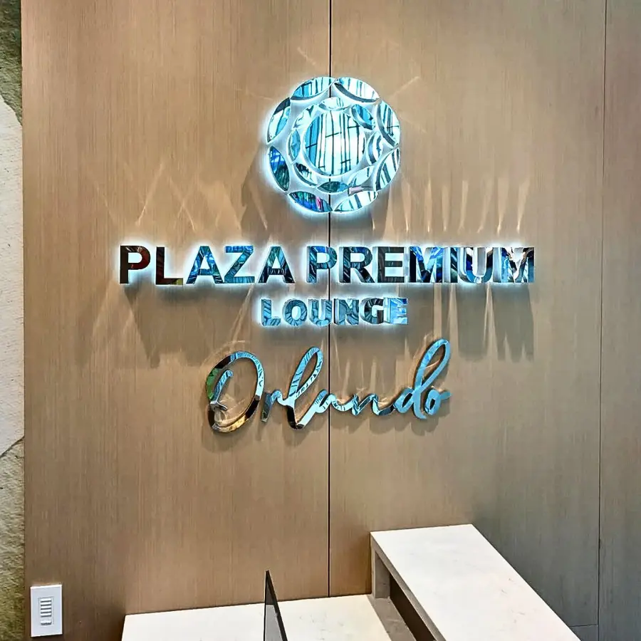 Plaza Premium Lounge Orlando illuminated logo inside the lounge